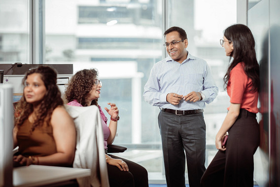 A group of smiling colleagues stood together in the office