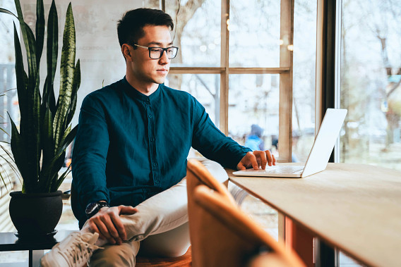 businessperson working on laptop in modern office