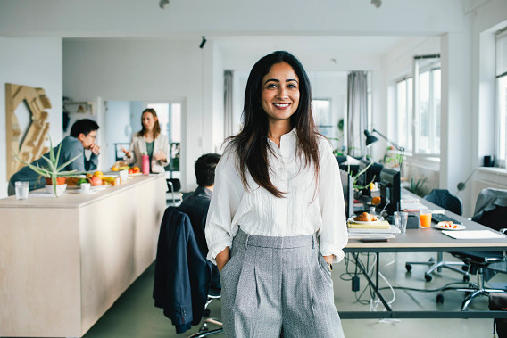 Woman in office looking to camera