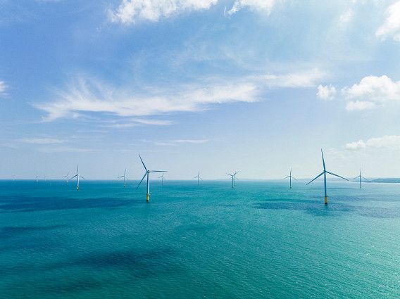 Offshore wind power installation stands majestically in the sea, with rows of turbines harnessing the power of the wind to generate renewable energy